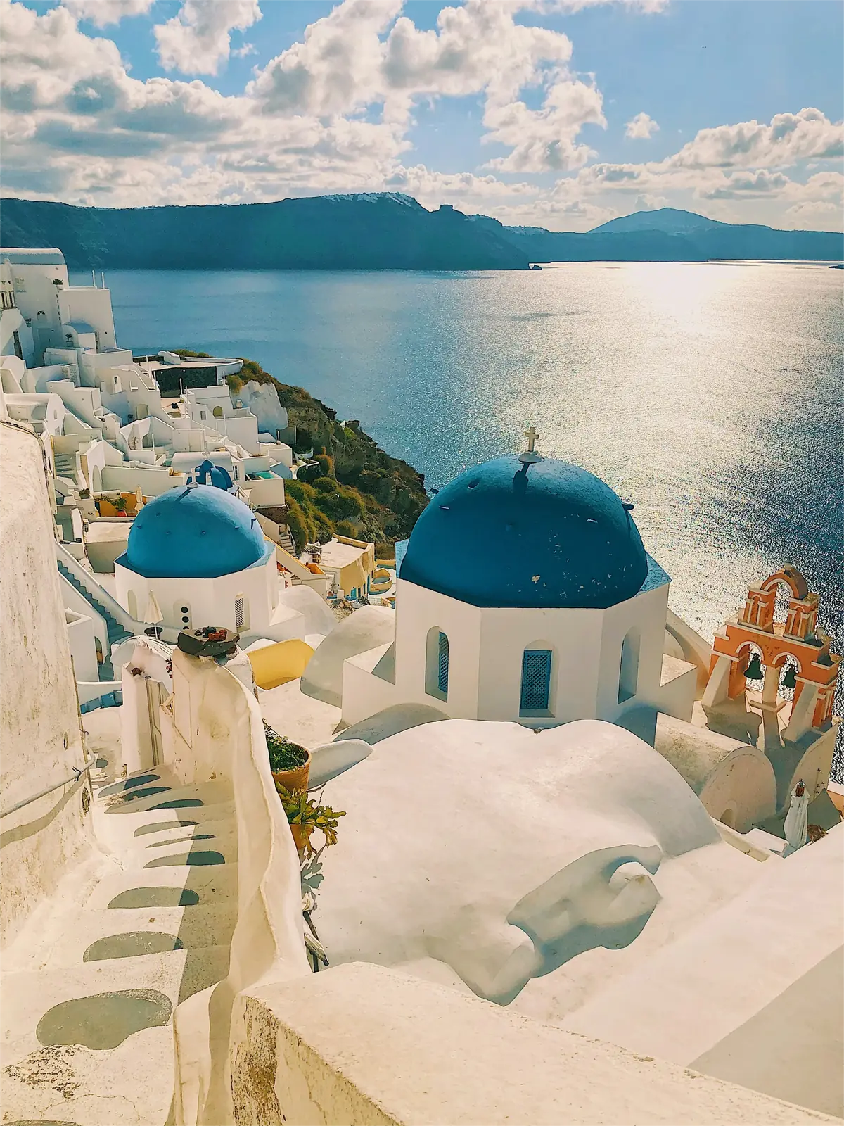 Santorini cliffside with white buildings and caldera view at dusk